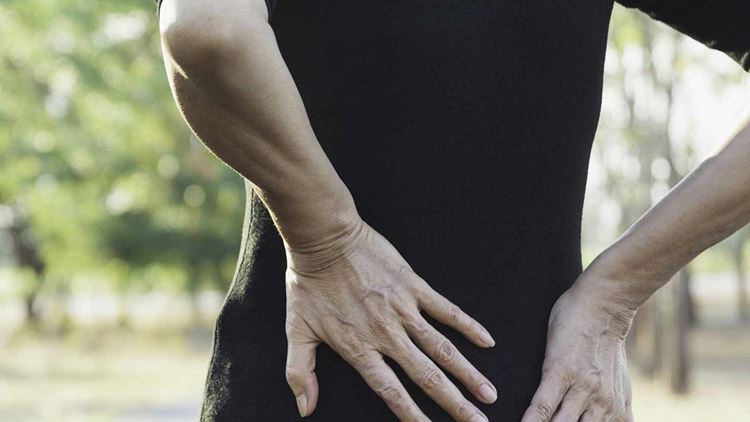 A woman stretching her back