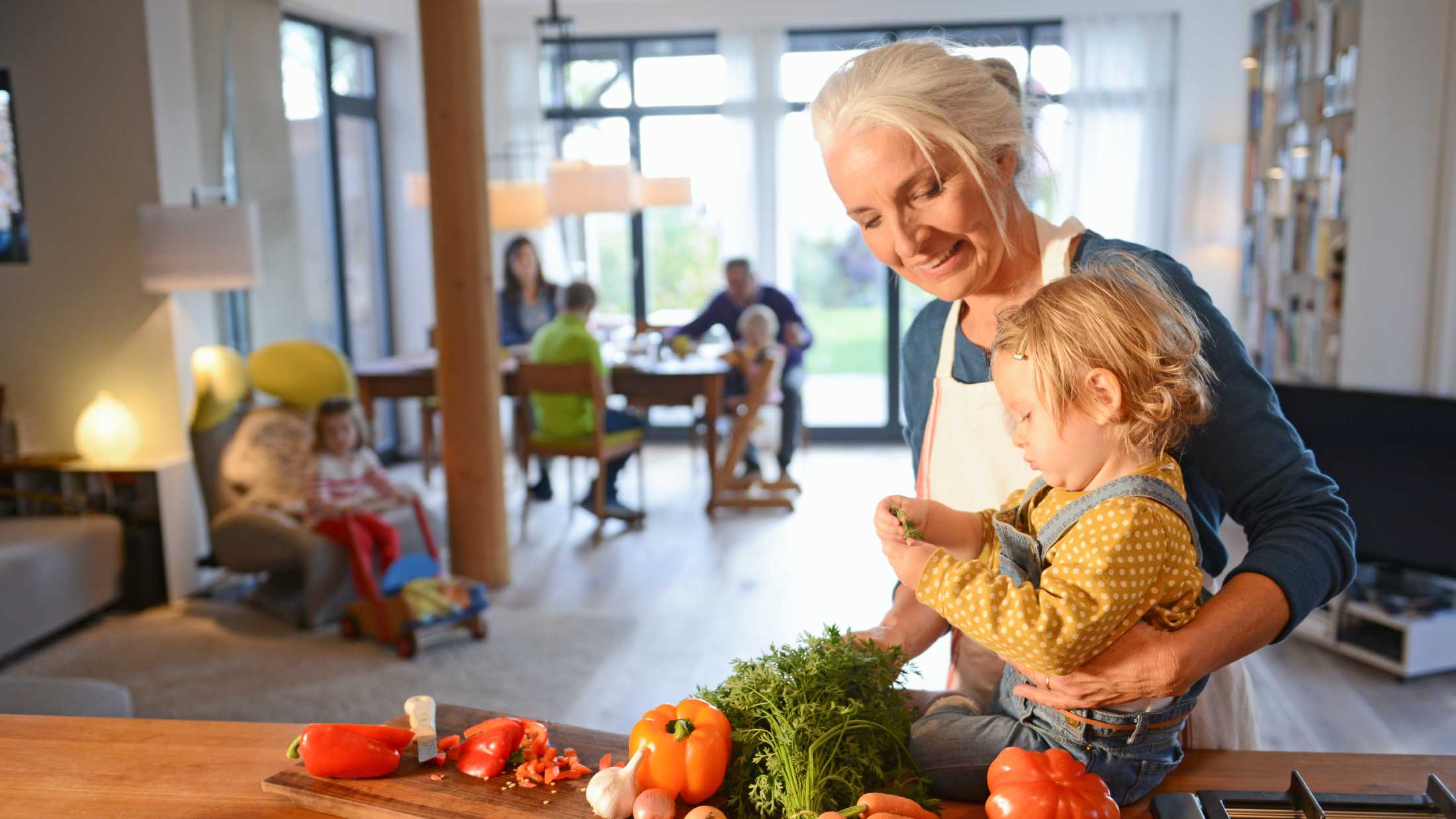grandmother with her grandchild preparing vegetables