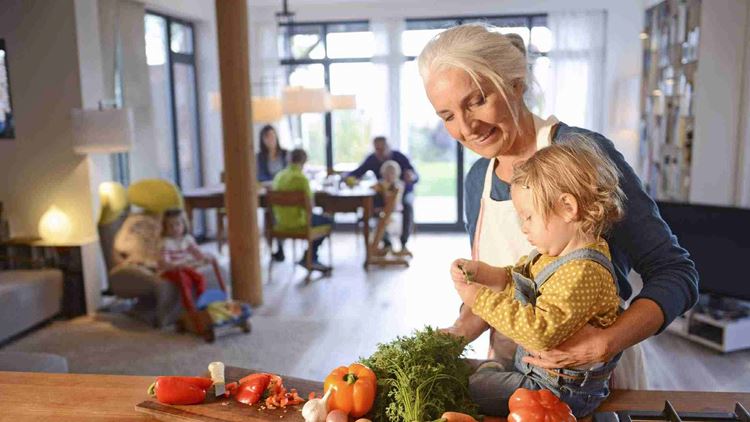 Grandmother with her grandchild preparing vegetables