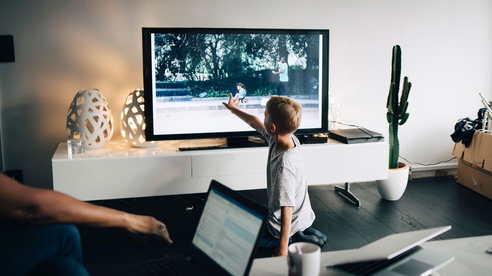 child standing in front of tv