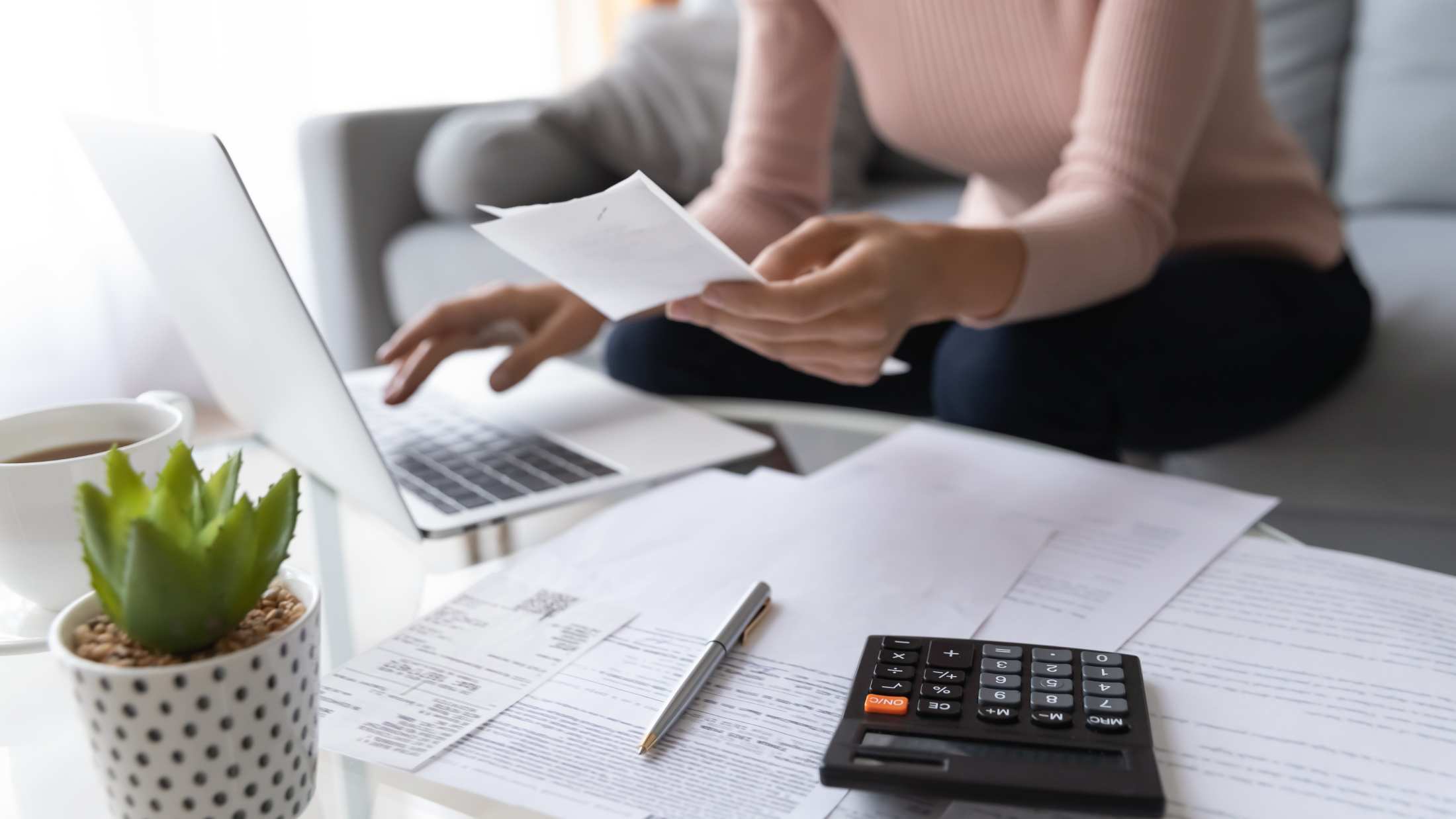 Woman sat in front of her laptop managing her insurance policy online