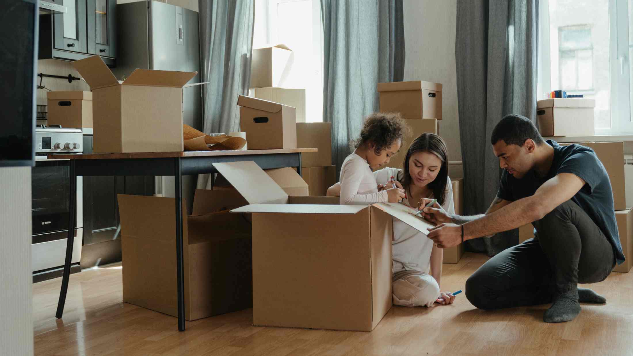 Family packing up boxes ready to move house