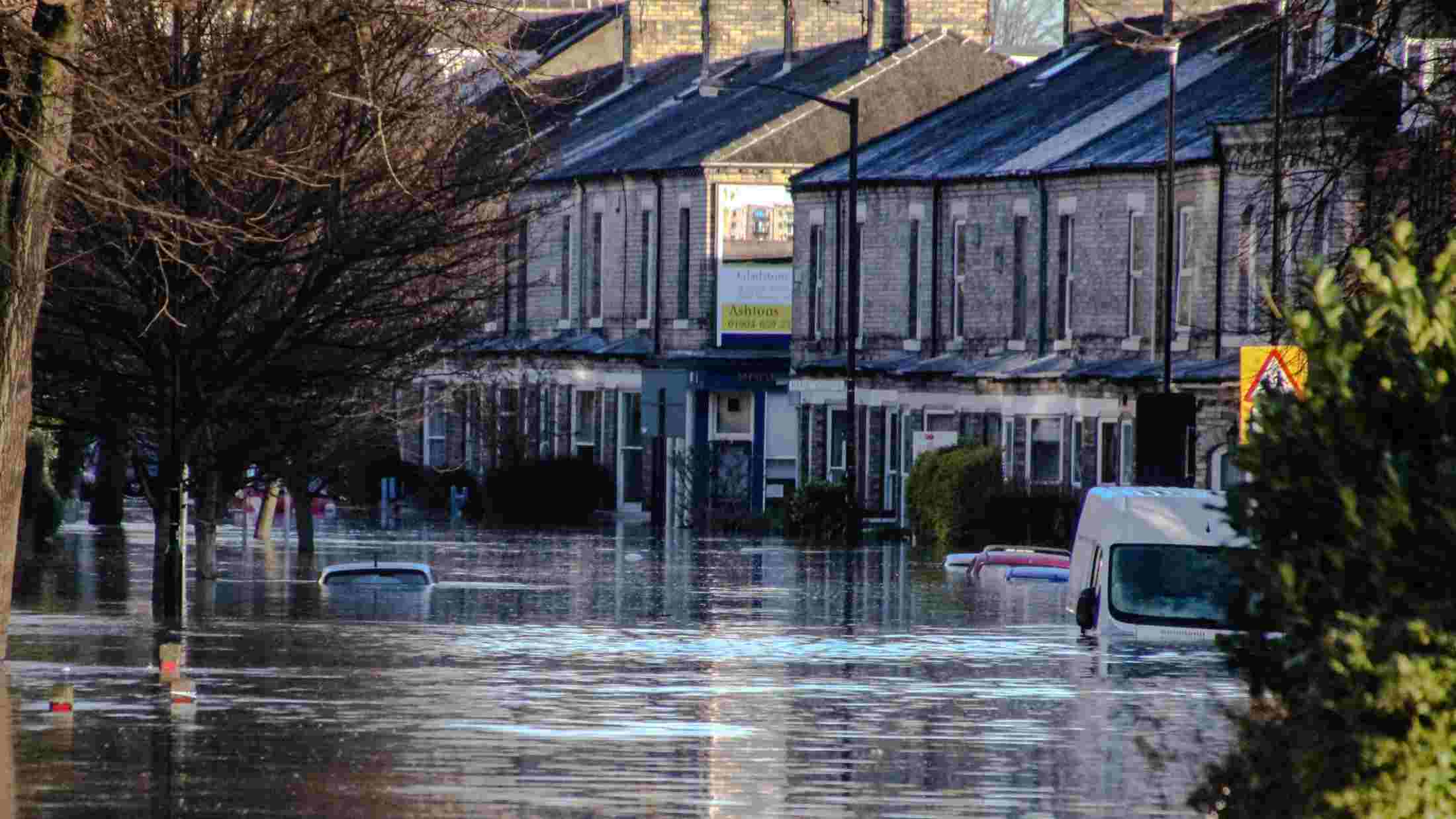 Flooded covering cars and ground floor of a building in a residential street in york
