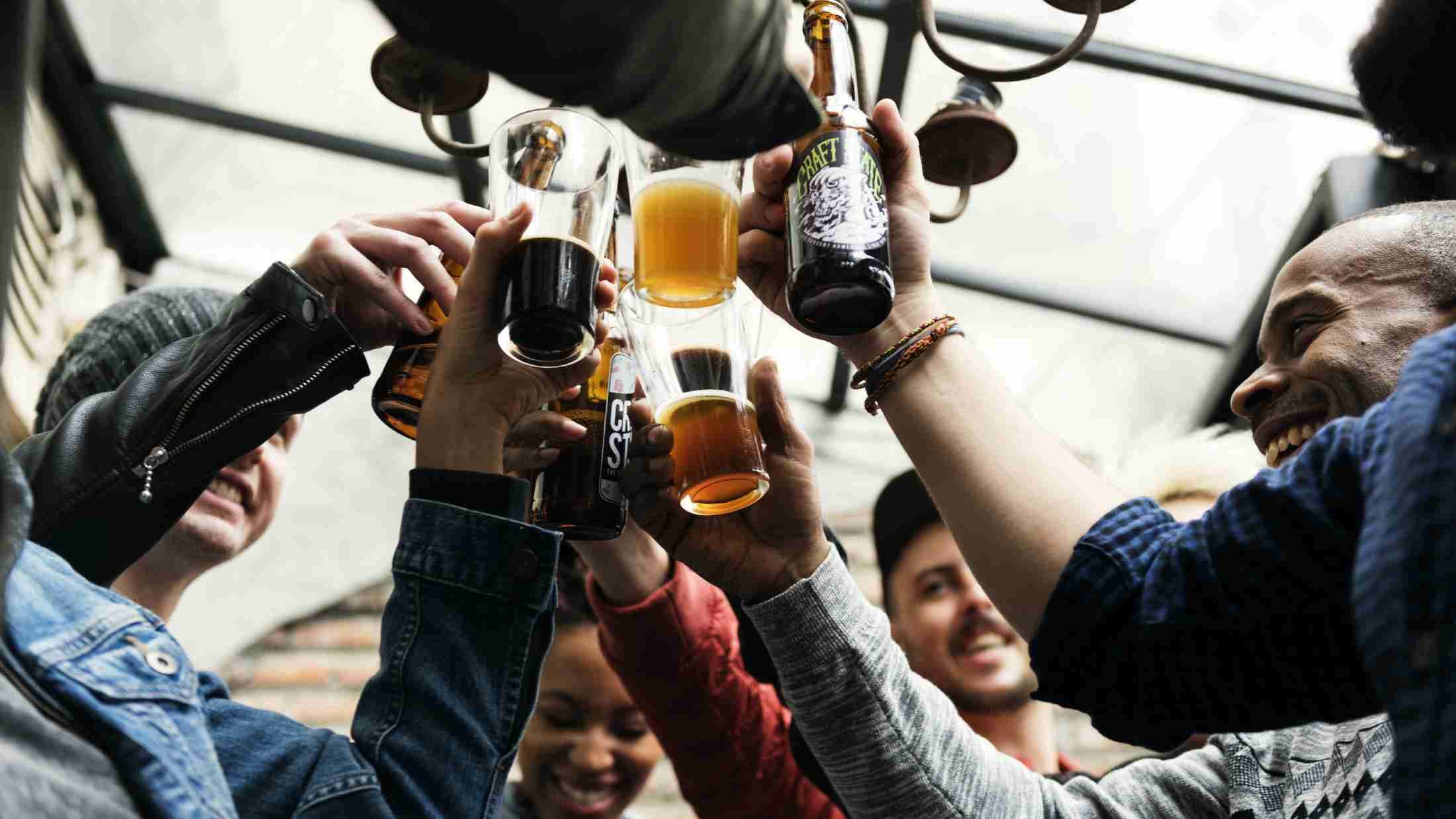 Group of friends clinking their beer glasses