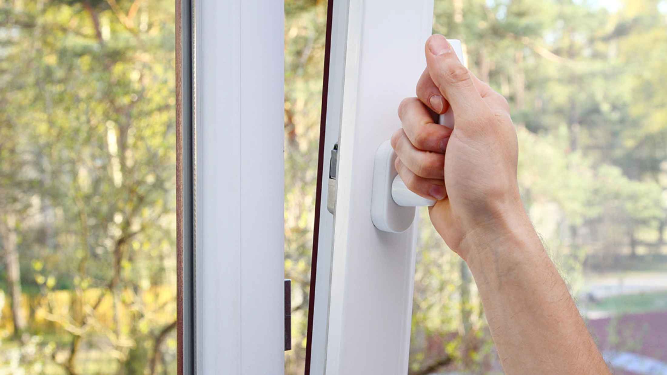 Hand opening a plastic vinyl window