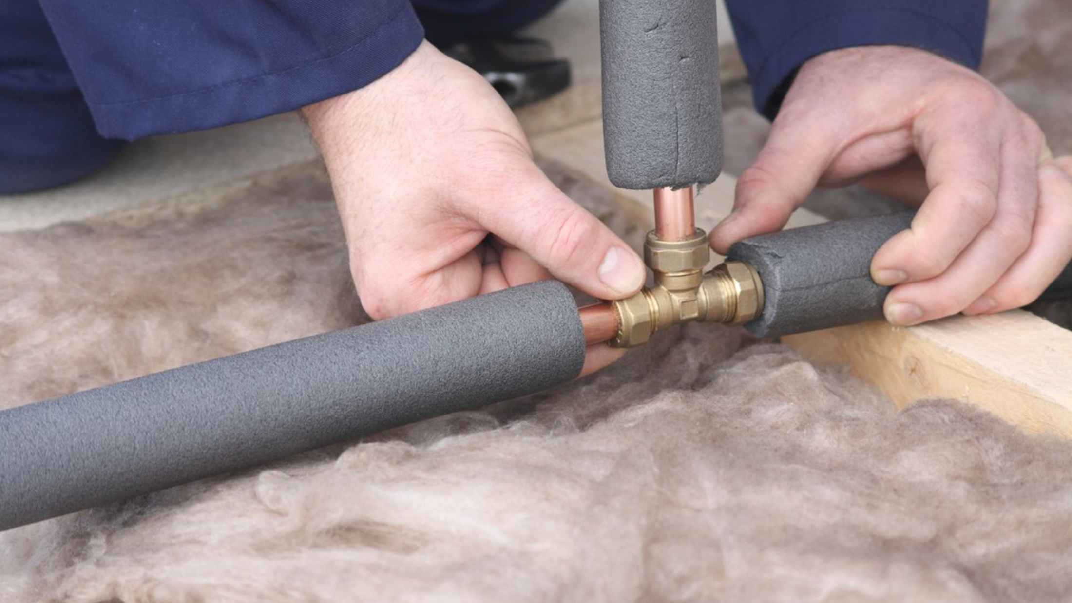 Plumber connecting copper water pipes
