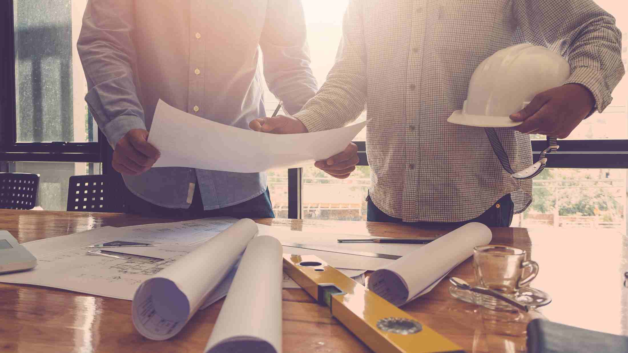 Two men looking at architectural plans