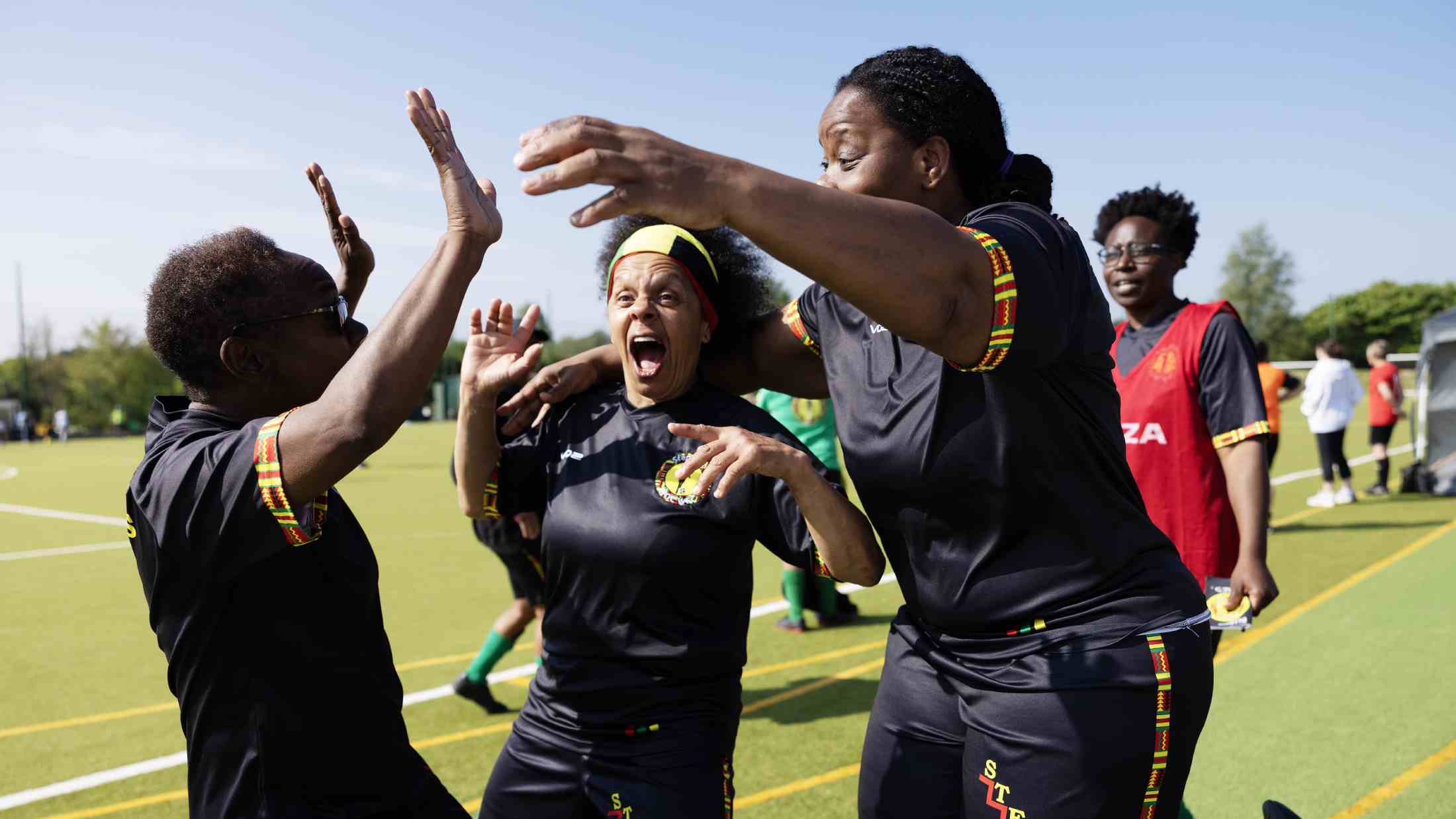 Football team celebrating after scoring a goal