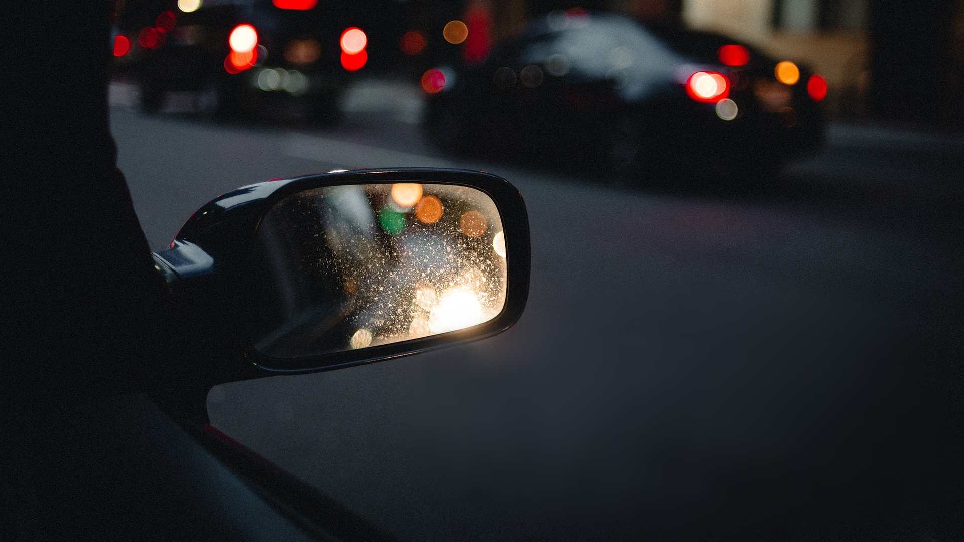 Car wing mirror at night
