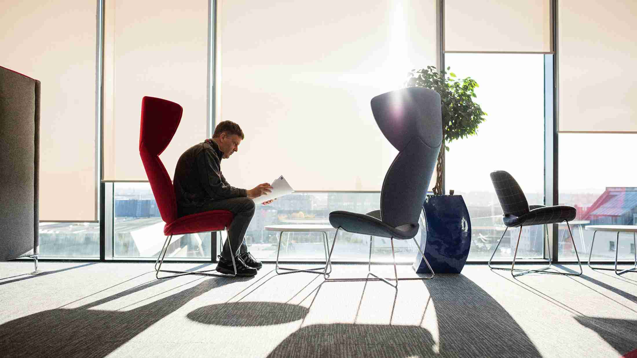 A businessman reads a report in a window seat
