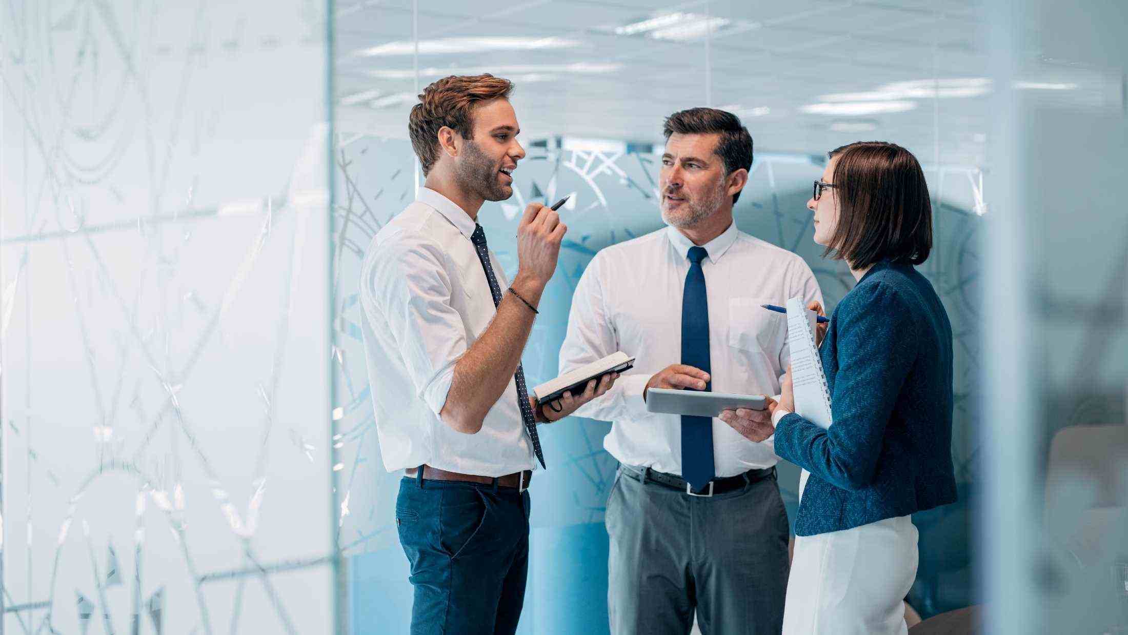 Group of businesspeople talking together in office