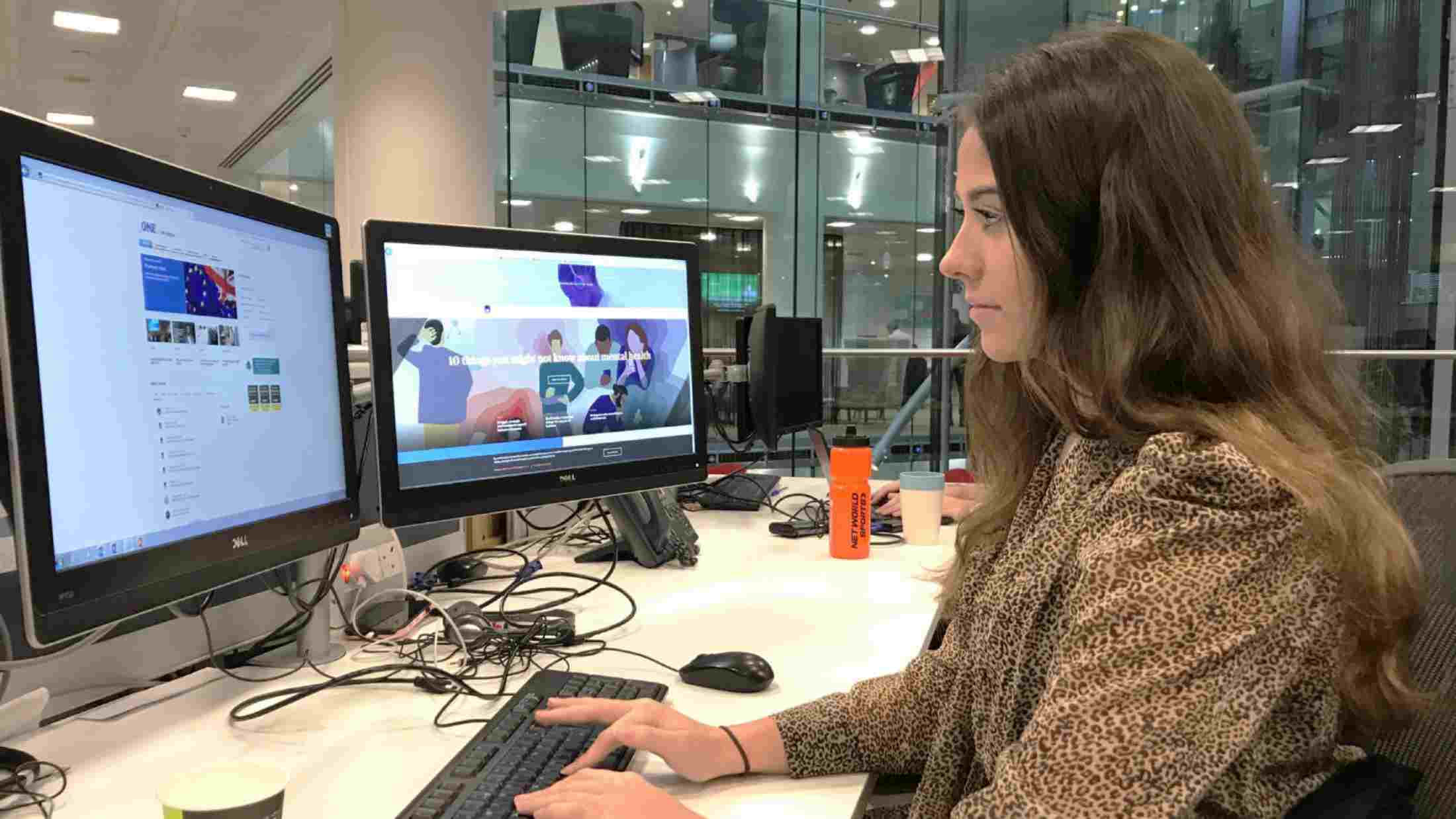 Mia Simpson, PR Apprentice, sat at her desk in AXA's London Office on Old Broad Street