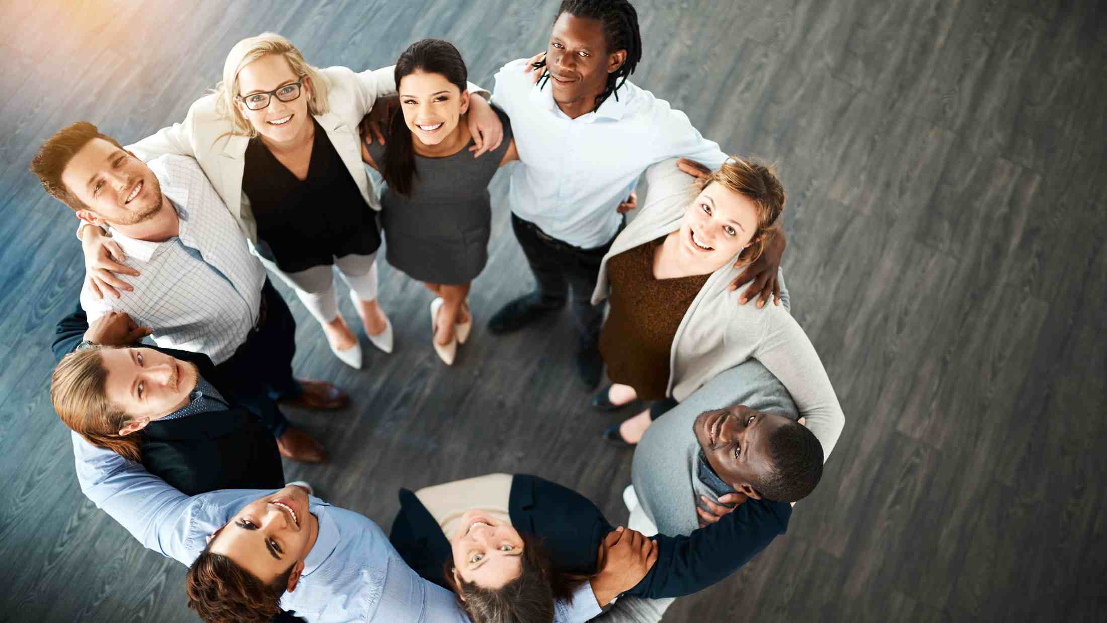 High angle portrait of a group of young business people huddled together in solidarity