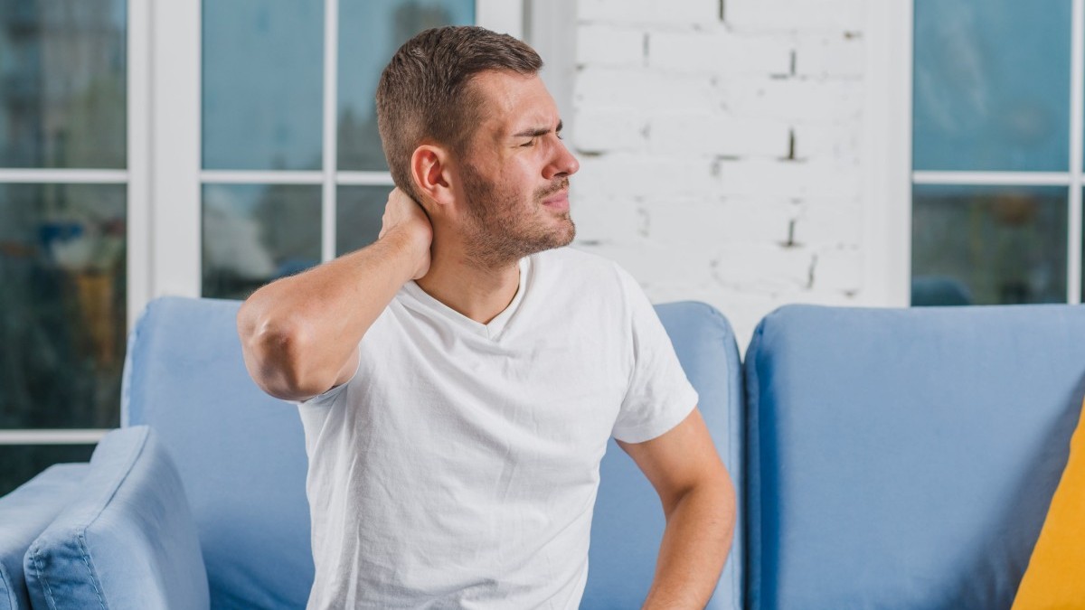 Man holding his neck