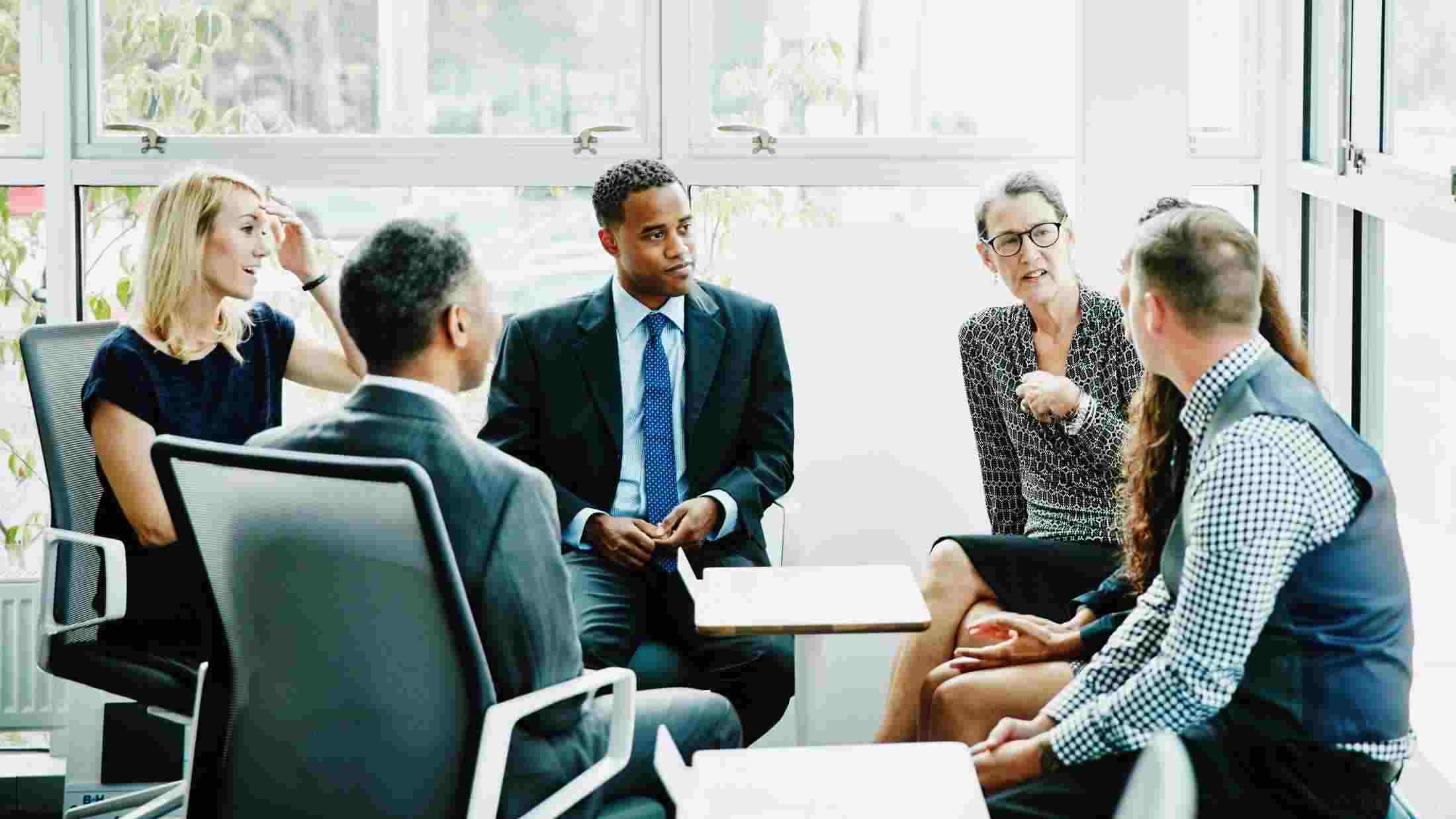 Mature businesswoman leading team meeting in conference room