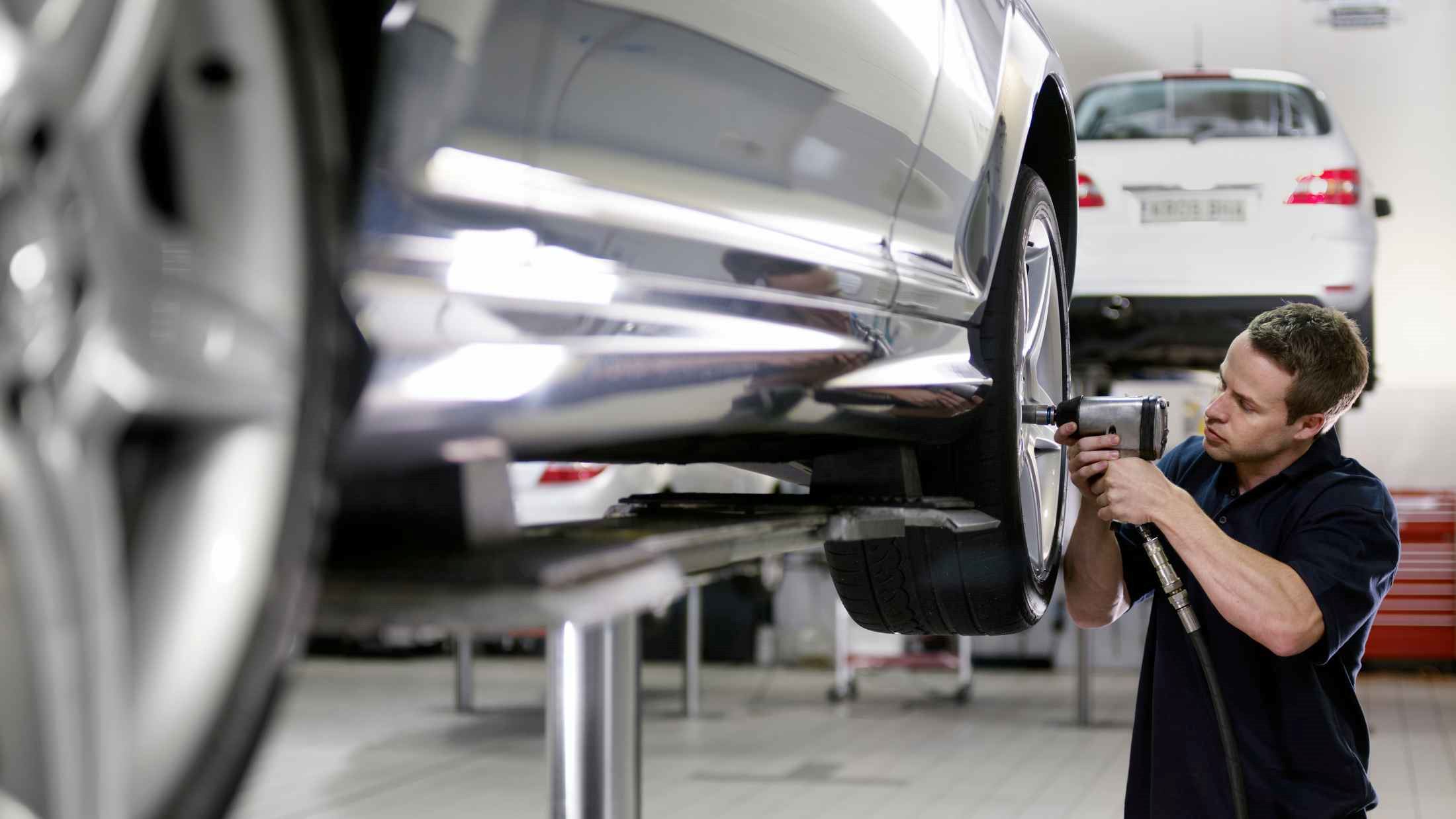 Mechanic working on car in auto repair shop