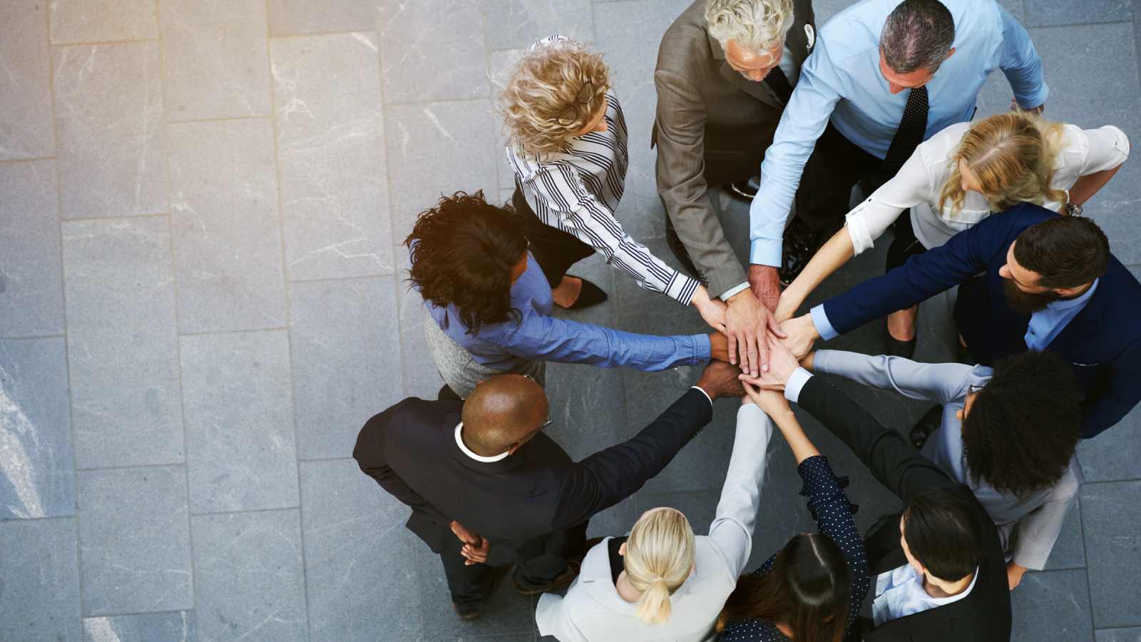 Group of people putting their hands together