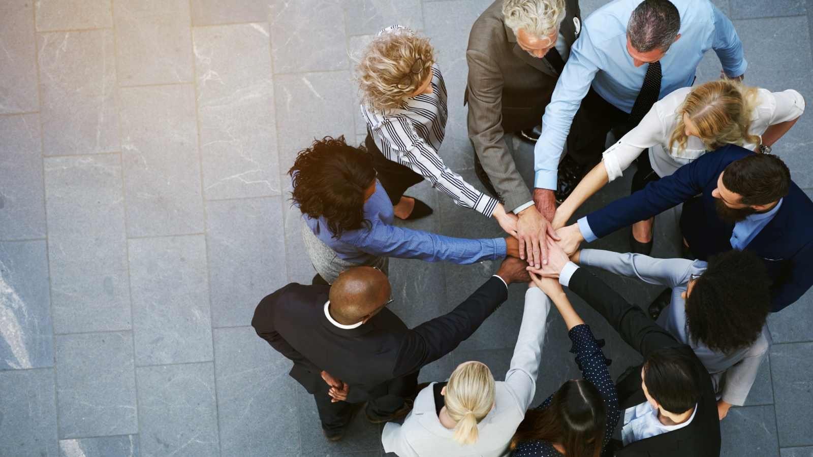 Group of people putting their hands together