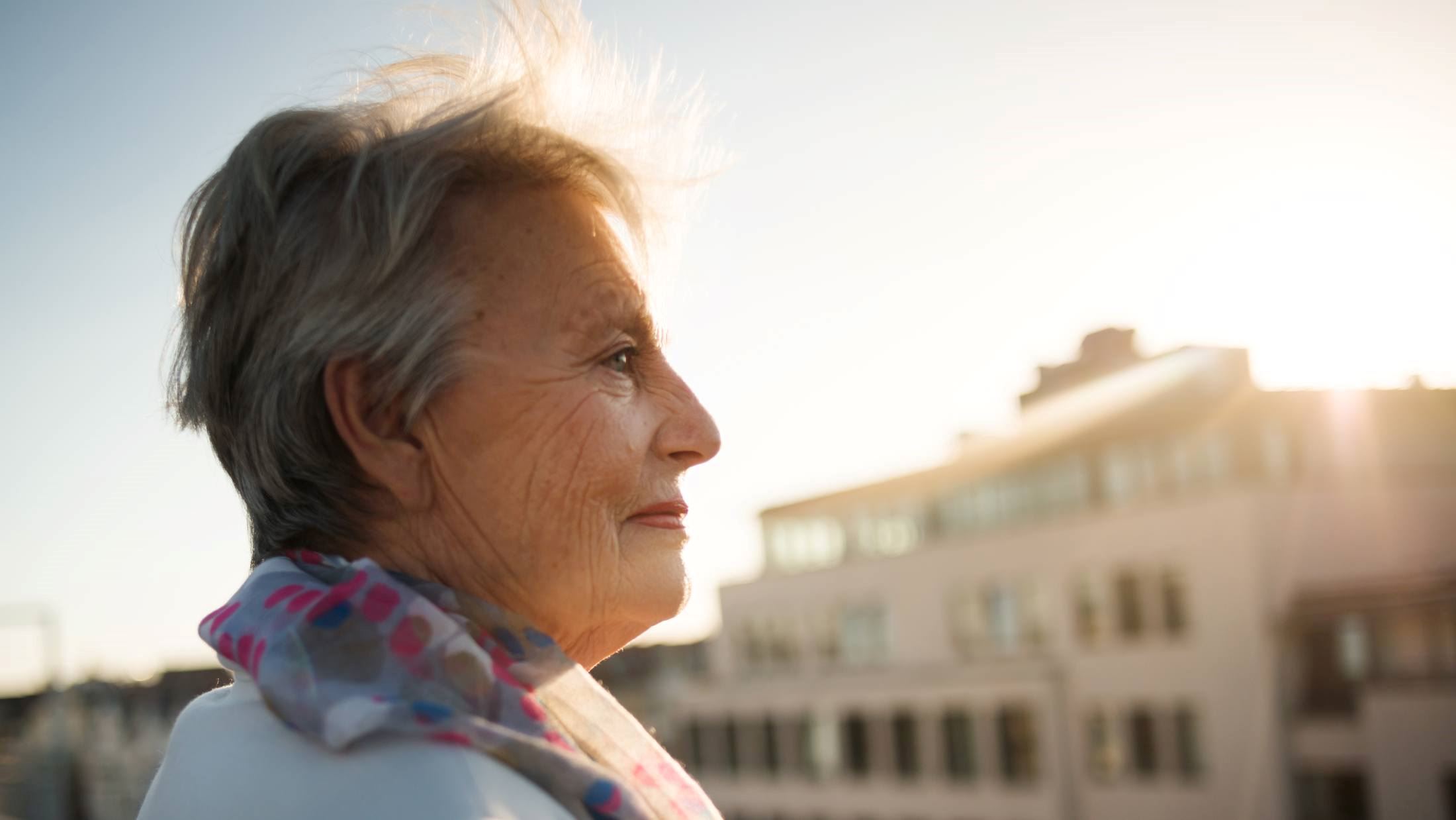 Senior woman standing on a roofgarden