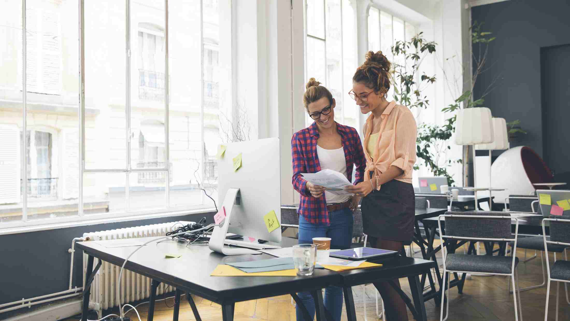 Two female SME business owners working in an office