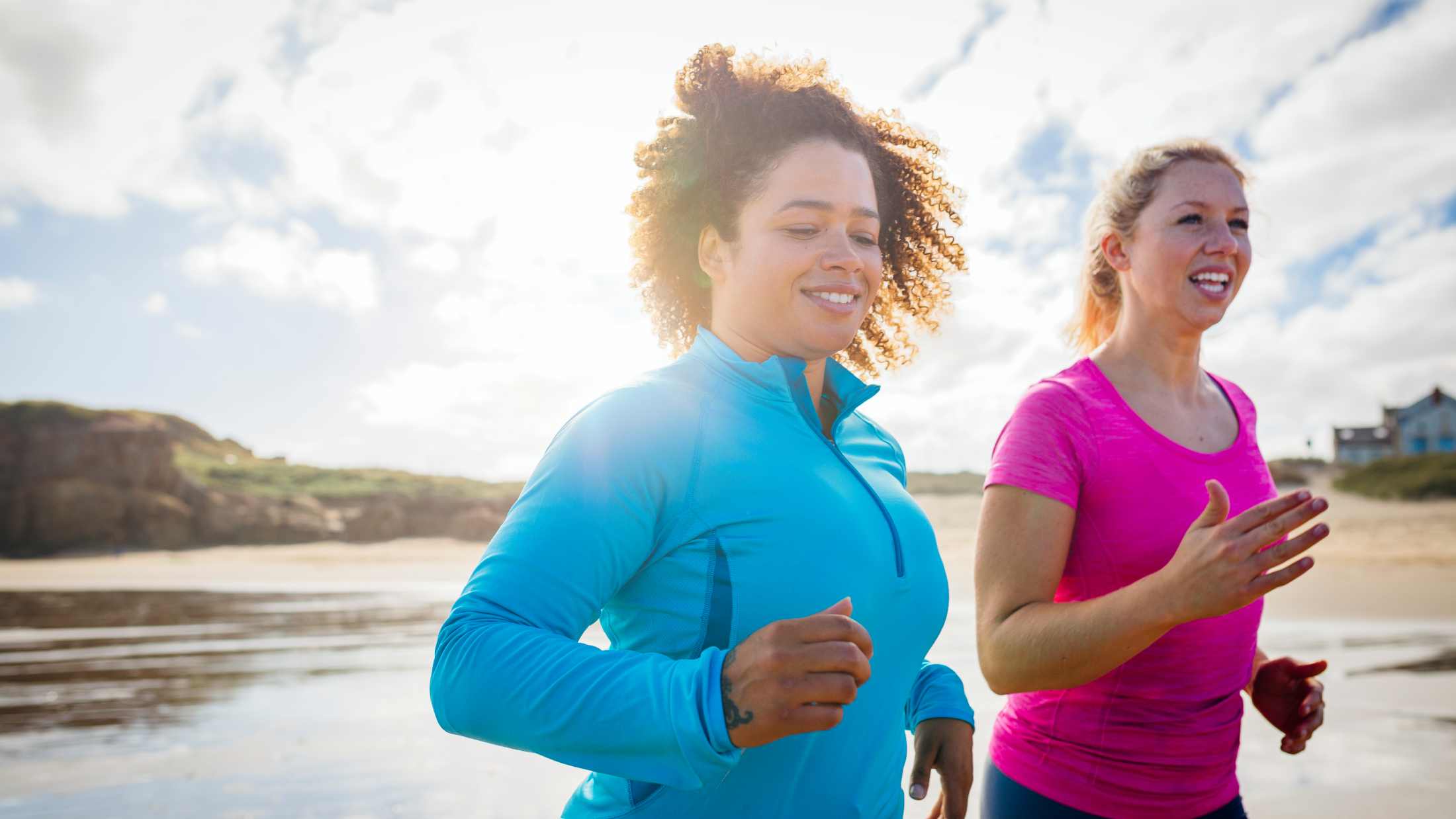 women running along the shoreline