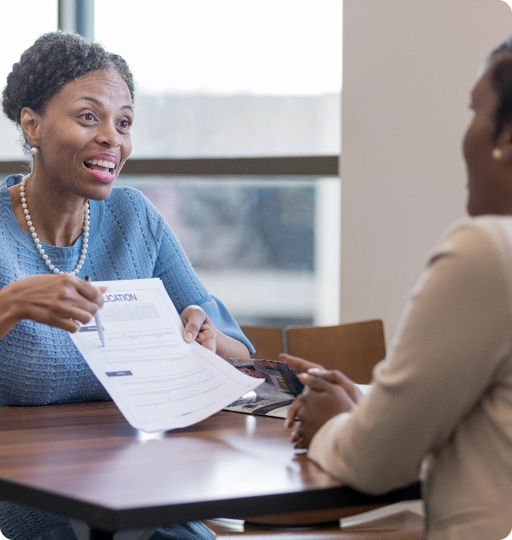 two-woman-talking-over-a-legal-document