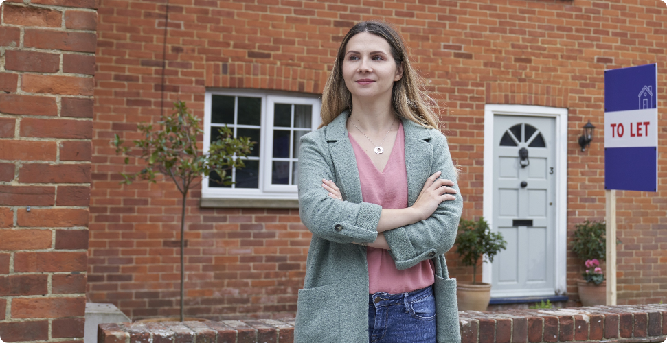 Woman standing in front of her house she has for let